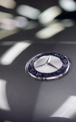 A company logo is seen on a Mercedes-Benz A-class car displayed in a dealership of German car manufacturer Daimler in Paris