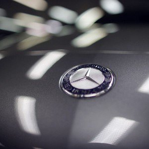 A company logo is seen on a Mercedes-Benz A-class car displayed in a dealership of German car manufacturer Daimler in Paris